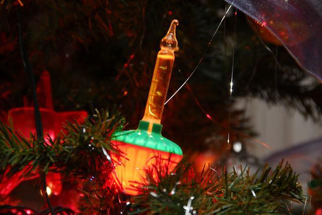 Close-up of vintage Christmas bubble lights on a tree, glowing and bubbling