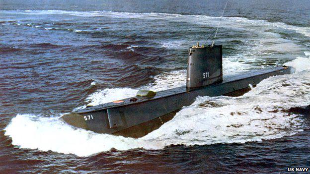 The USS Nautilus cruising on the surface of the ocean, leaving a wake behind it