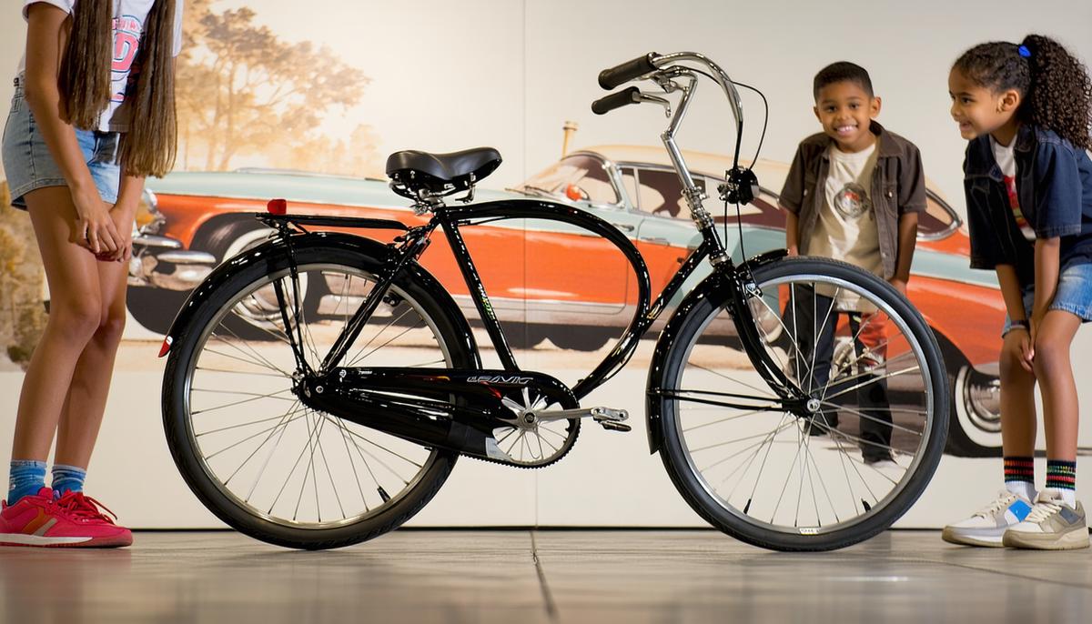 A Schwinn Black Phantom bicycle displayed in front of a 1950s American backdrop with teenagers admiring it